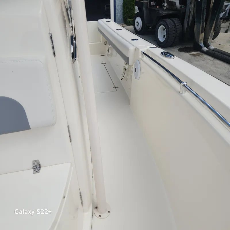 Slide: The Image of 2018 Cobia 261 Center Console boat interior with seating and railings. - 27