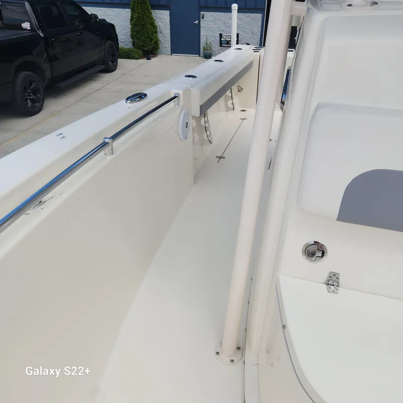 Slide: The Image of 2018 Cobia 261 Center Console boat interior, featuring sleek white design and modern fittings. - 28
