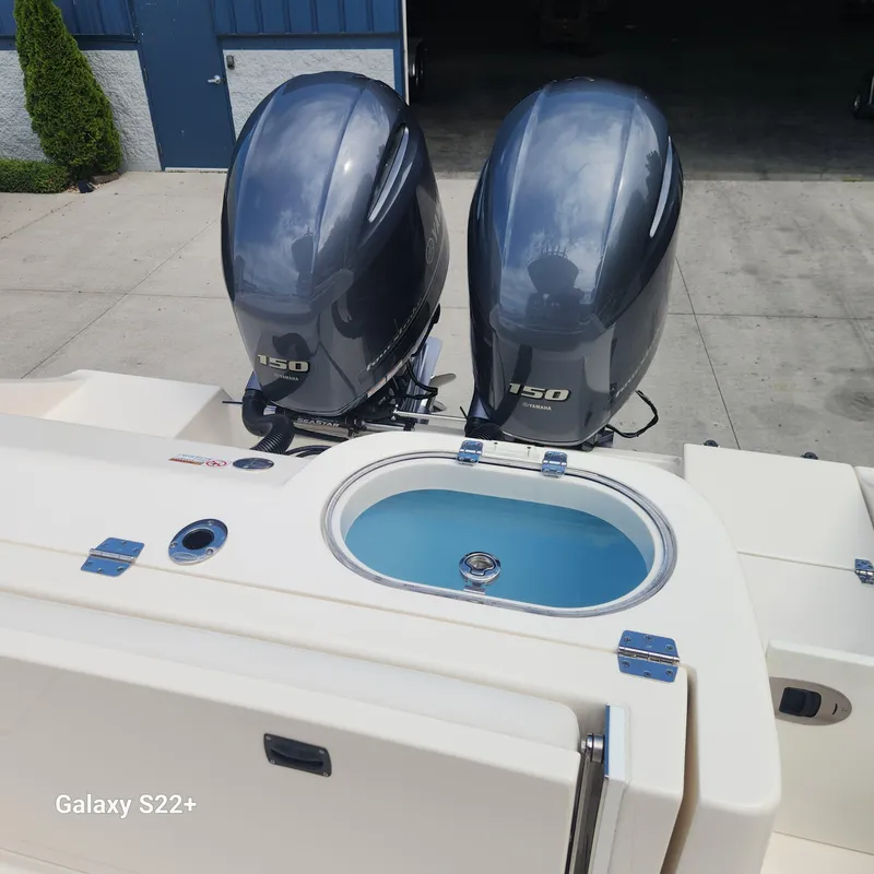Slide: The Image of 2018 Cobia 261 Center Console with dual 150 horsepower engines and livewell. - 29