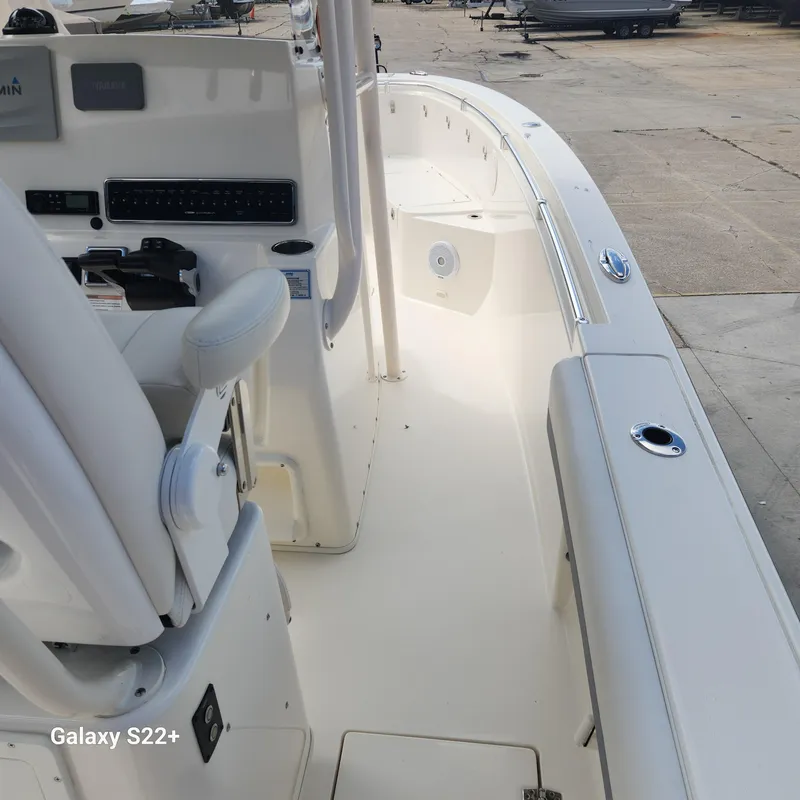 Slide: The Image of 2018 Cobia 261 Center Console boat interior with seating and control panel. - 9