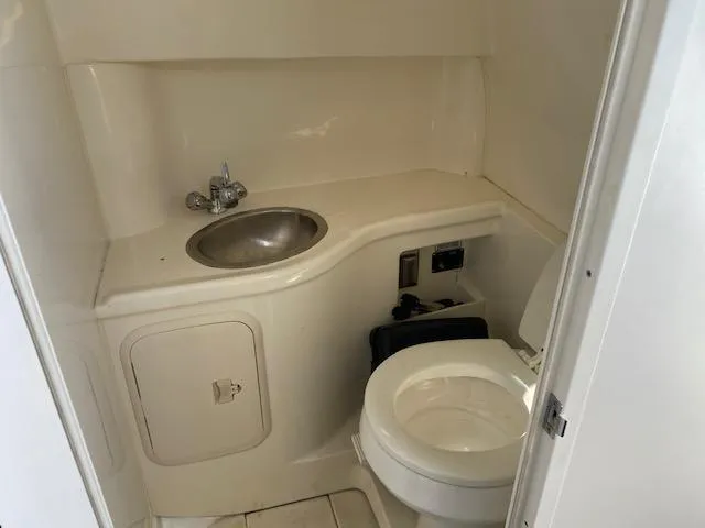 Slide: The Image of 2005 Boston Whaler 275 Conquest boat bathroom with sink and toilet. - 10