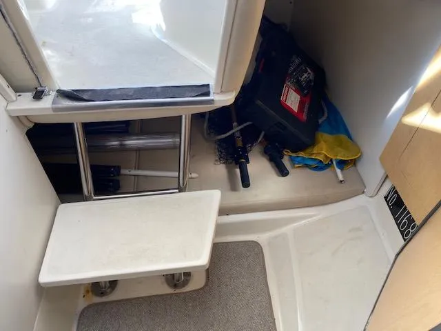 Slide: The Image of 2005 Boston Whaler 275 Conquest cabin interior with storage and equipment. - 14