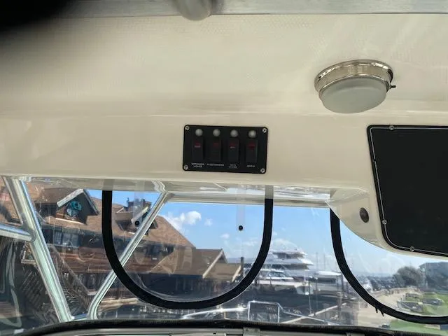 Slide: The Image of Interior view of 2005 Boston Whaler 275 Conquest boat with control panel and window. - 17