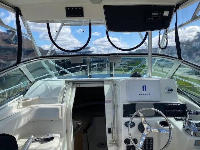 Slide: The Image of 2005 Boston Whaler 275 Conquest boat cockpit with steering wheel and navigation equipment. - 7