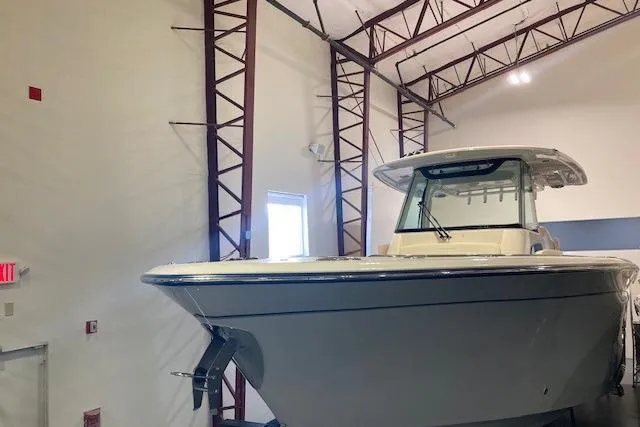 Slide: The Image of 2026 Grady-White Canyon 336 boat in indoor storage facility. - 0