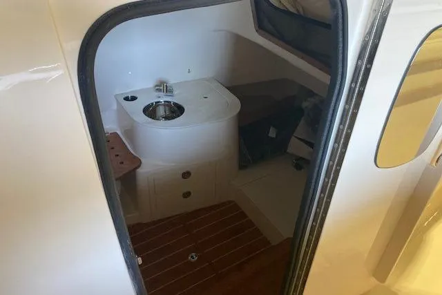 Slide: The Image of 2026 Grady-White Canyon 336 boat interior with sink and wooden flooring. - 14