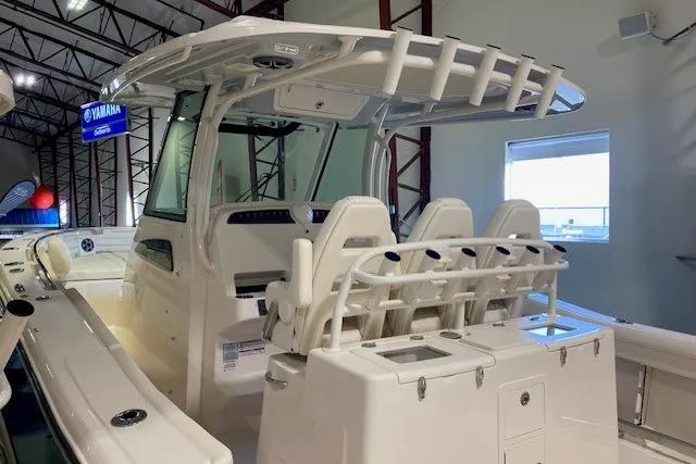 Slide: The Image of 2026 Grady-White Canyon 336 boat interior with seating and helm station in showroom. - 2