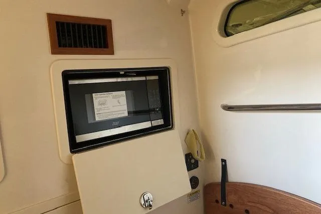 Slide: The Image of Interior of 2026 Grady-White Canyon 336 boat with microwave and storage. - 20