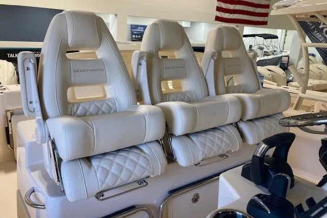 Slide: The Image of Luxury seating on 2026 Grady-White Canyon 336 boat, featuring plush white upholstery. - 21