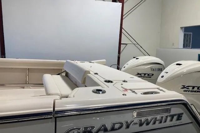 Slide: The Image of 2026 Grady-White Canyon 336 boat with Yamaha XTO engines in a showroom. - 3