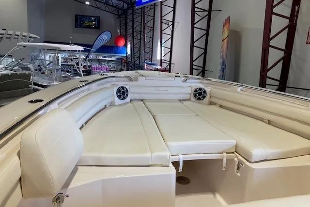 Slide: The Image of 2026 Grady-White Canyon 336 boat interior with cushioned seating and speakers. - 8