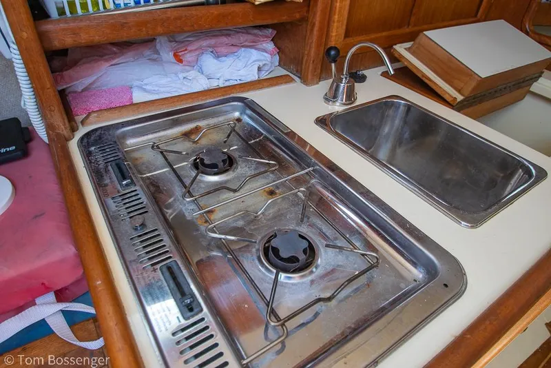 Slide: The Image of Compact galley kitchen in 1993 Pacific Seacraft Flicka 20 sailboat with stove and sink. - 11