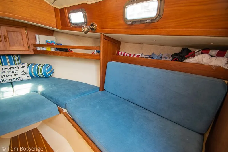 Slide: The Image of Interior of 1993 Pacific Seacraft Flicka 20 sailboat with blue cushions and wooden cabinetry. - 14