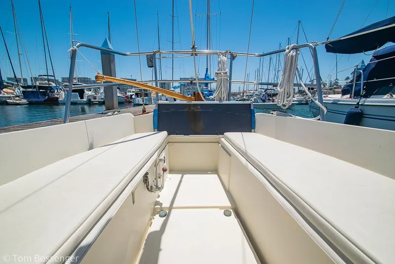 Slide: The Image of 1993 Pacific Seacraft Flicka 20 sailboat cockpit view in marina, clear sky background. - 21