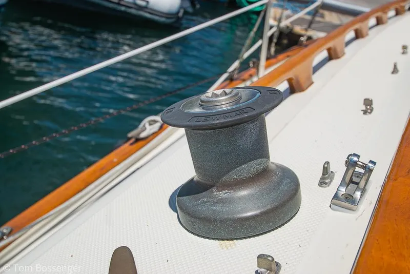 Slide: The Image of Winch on 1993 Pacific Seacraft Flicka 20 sailboat deck, with wooden trim and water background. - 25