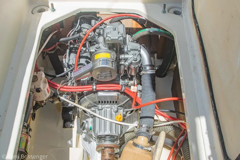 Slide: The Image of Engine compartment of a 1993 Pacific Seacraft Flicka 20 sailboat, showing detailed wiring and components. - 34