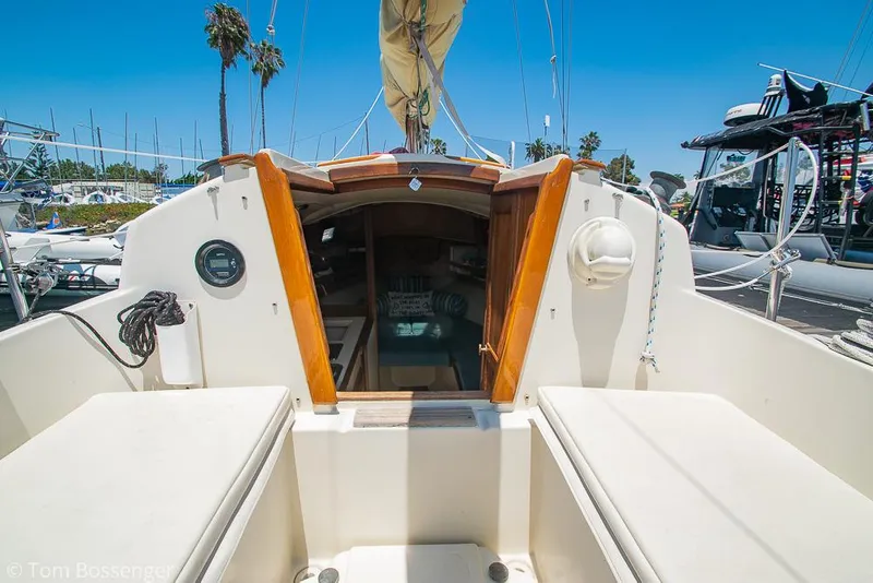 Slide: The Image of 1993 Pacific Seacraft Flicka 20 sailboat cockpit with open cabin, docked under clear blue sky. - 5