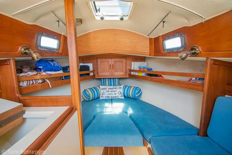 Slide: The Image of Cozy interior of 1993 Pacific Seacraft Flicka 20 sailboat with blue cushions and wooden accents. - 7