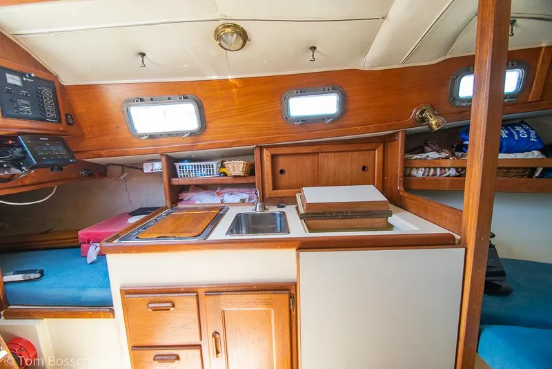 Slide: The Image of Interior of 1993 Pacific Seacraft Flicka 20 sailboat with compact kitchen and cozy seating. - 8