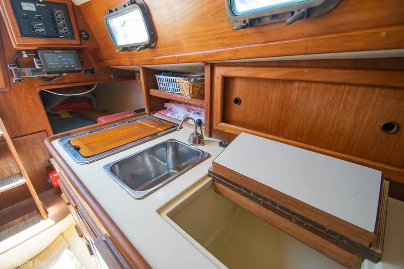 Slide: The Image of Interior of 1993 Pacific Seacraft Flicka 20 sailboat, featuring a compact kitchen area. - 9