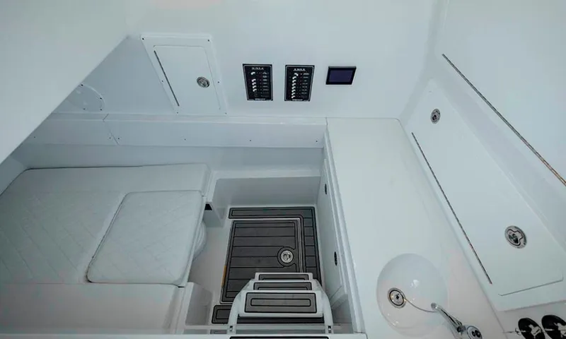 Slide: The Image of 2024 Onslow Bay 37 interior cabin with seating, control panels, and sink. - 14