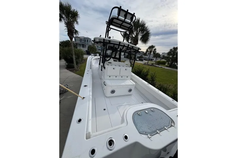Slide: The Image of 2024 Onslow Bay 37 Tournament boat with spacious deck and seating, set against a coastal backdrop. - 17