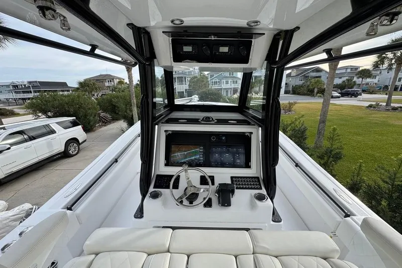 Slide: The Image of 2024 Onslow Bay 37 Tournament boat cockpit with modern controls and steering wheel. - 21