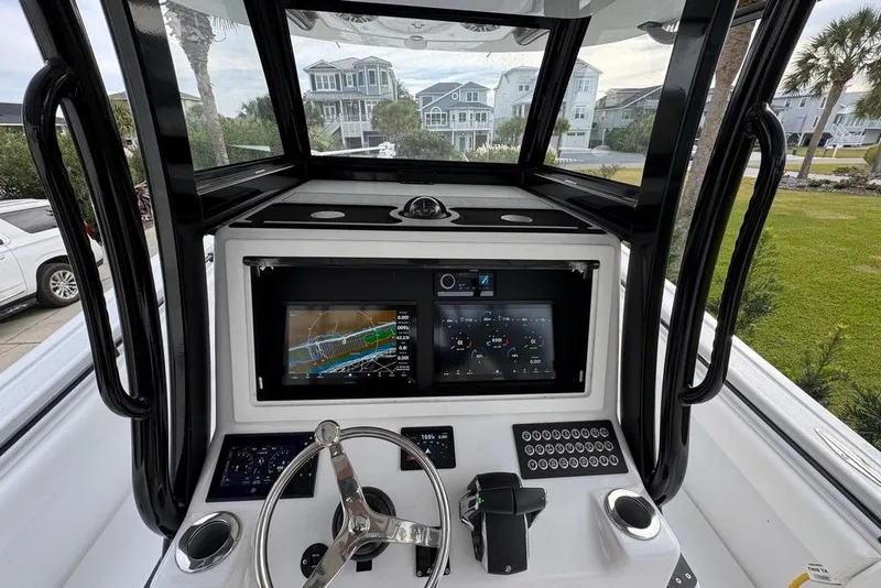 Slide: The Image of 2024 Onslow Bay 37 Tournament boat cockpit with advanced navigation displays. - 23