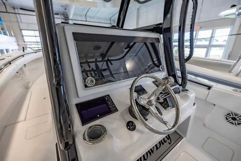 Slide: The Image of 2024 Onslow Bay 37 Tournament boat console with steering wheel and navigation display. - 32