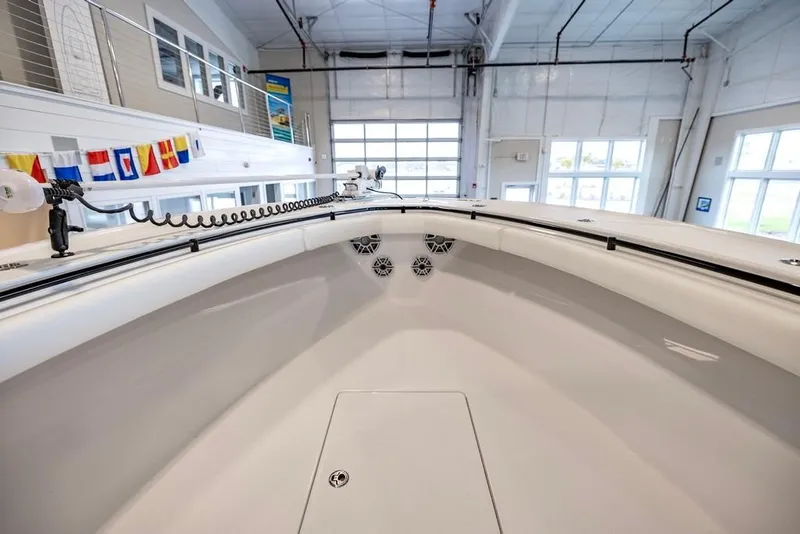 Slide: The Image of 2024 Onslow Bay 37 Tournament boat interior in a showroom with nautical flags. - 40