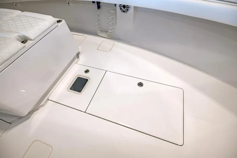 Slide: The Image of 2024 Onslow Bay 37 Tournament boat interior with white seating and storage compartments. - 43