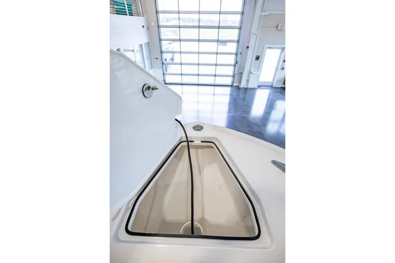 Slide: The Image of Open storage compartment on 2024 Onslow Bay 37 Tournament boat in a showroom. - 48
