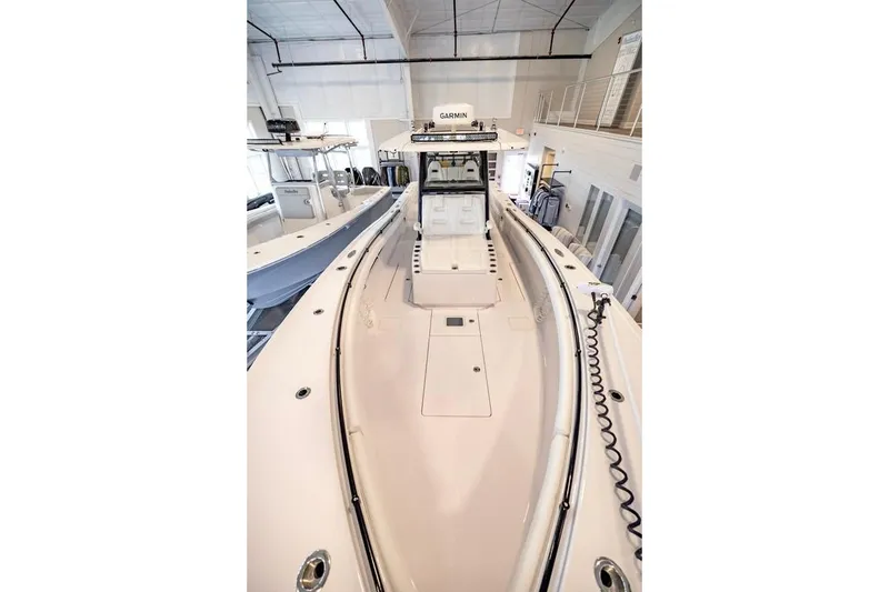 Slide: The Image of 2024 Onslow Bay 37 Tournament boat displayed in a showroom setting. - 50