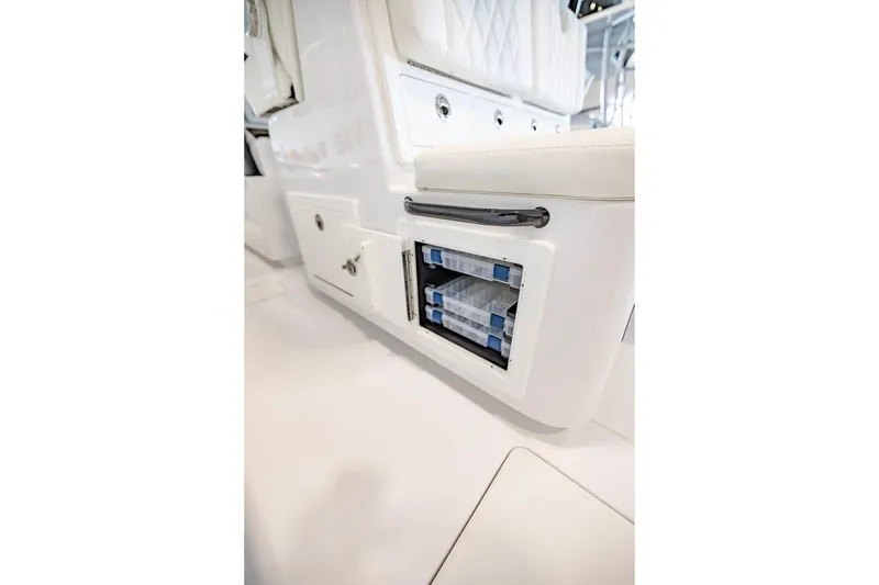 Slide: The Image of 2024 Onslow Bay 37 Tournament boat interior storage compartment with tackle boxes. - 56