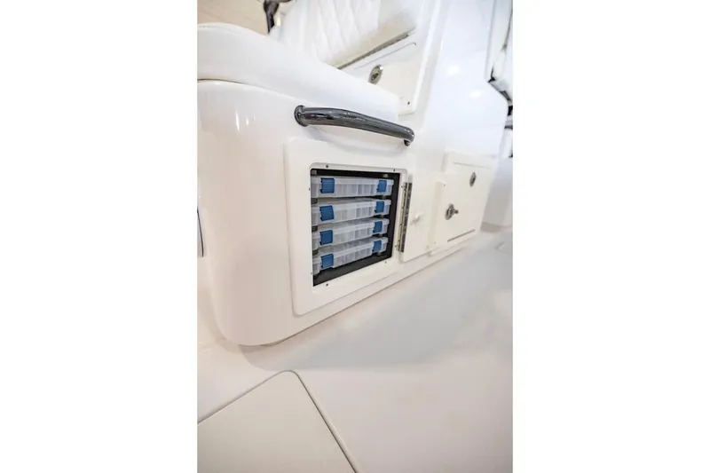 Slide: The Image of 2024 Onslow Bay 37 Tournament boat storage compartment with organized tackle boxes. - 58