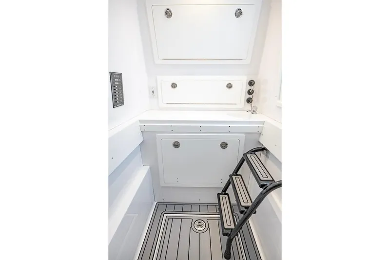 Slide: The Image of 2024 Onslow Bay 37 Tournament boat interior with storage compartments and ladder. - 62