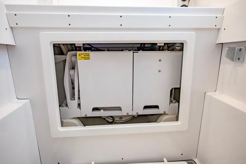 Slide: The Image of 2024 Onslow Bay 37 Tournament boat electrical compartment with safety warning label. - 63