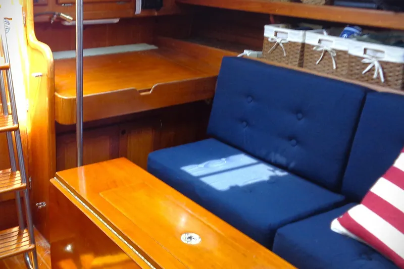 Slide: The Image of Interior of 1983 Bristol 41.1 yacht with wooden furnishings and blue seating. - 6