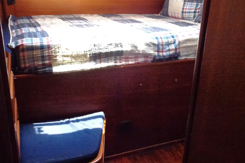 Slide: The Image of Cozy cabin bed with plaid bedding in a 1983 Bristol 41.1 yacht interior. - 4