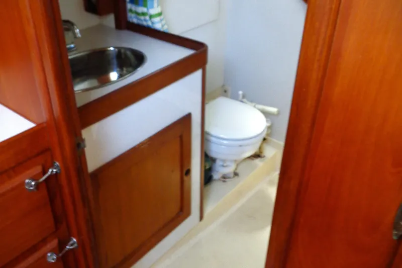 Slide: The Image of 1983 Bristol 41.1 yacht bathroom with wooden cabinetry and compact toilet. - 8