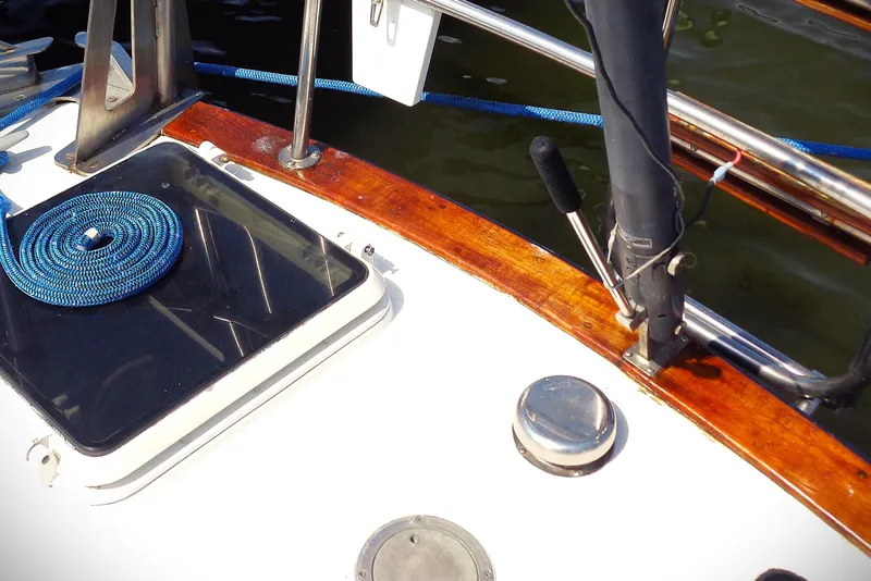 Slide: The Image of 1983 Bristol 41.1 yacht deck with blue rope and polished wood finish. - 15