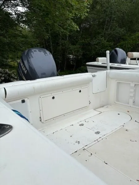 Slide: The Image of 1995 Wellcraft 238 Coastal boat interior with Yamaha outboard motor, surrounded by lush greenery. - 2