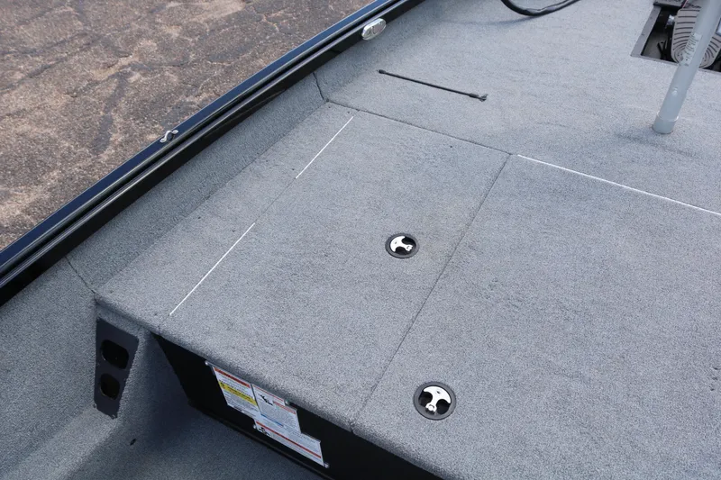 Slide: The Image of 2020 Alumacraft Pro 185 boat deck with storage compartments and gray carpeting. - 15