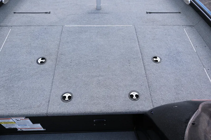 Slide: The Image of 2020 Alumacraft Pro 185 boat deck with storage compartments and carpeted surface. - 17