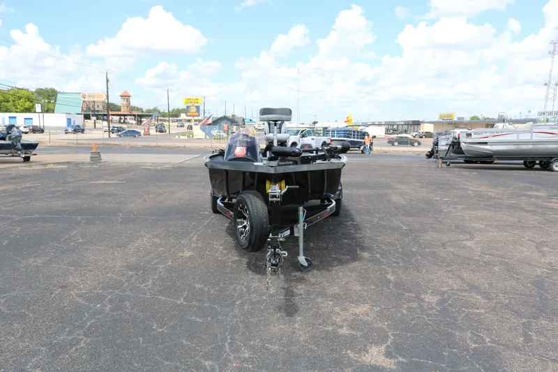 Slide: The Image of 2020 Alumacraft Pro 185 boat on trailer in parking lot, clear sky background. - 2