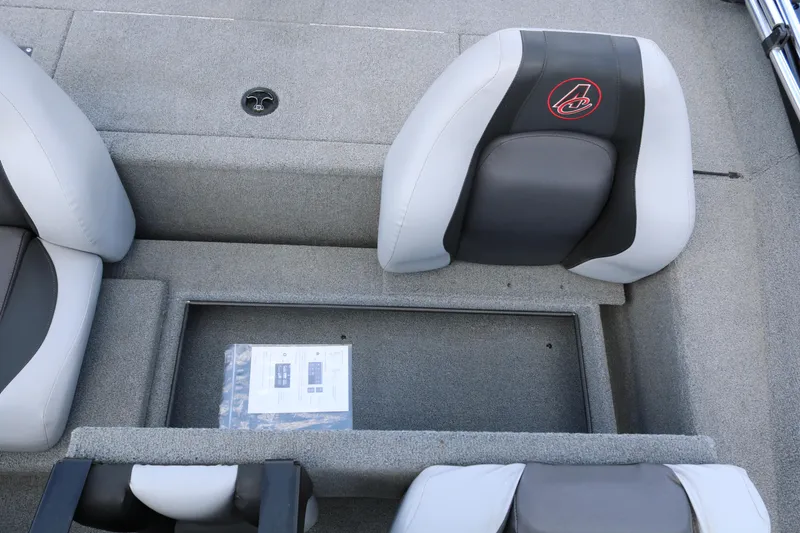 Slide: The Image of 2020 Alumacraft Pro 185 boat interior with gray seating and storage compartment. - 23