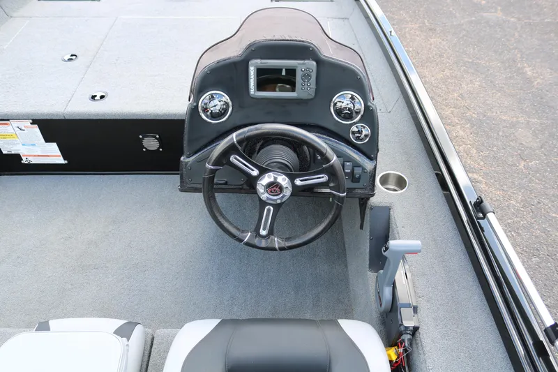 Slide: The Image of 2020 Alumacraft Pro 185 boat dashboard with steering wheel and controls. - 25