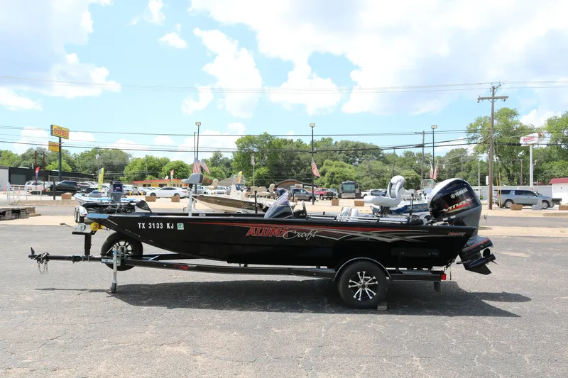 Slide: The Image of 2020 Alumacraft Pro 185 boat on trailer in parking lot, sunny day. - 4