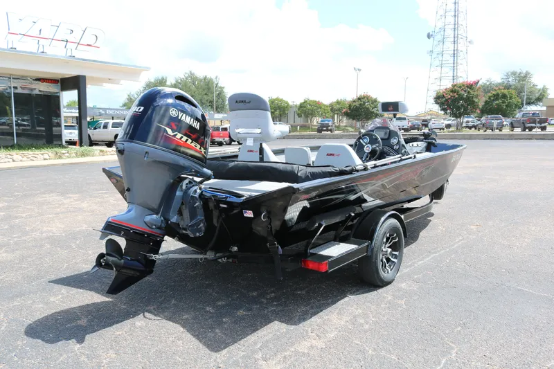 Slide: The Image of 2020 Alumacraft Pro 185 boat with Yamaha engine, parked outdoors on a sunny day. - 7