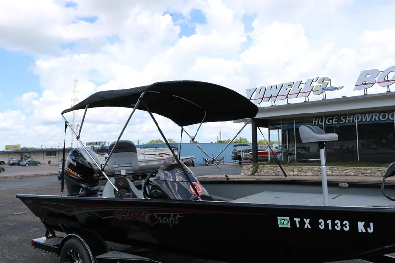 Slide: The Image of 2020 Alumacraft Pro 185 boat with canopy, parked outside a showroom. - 9